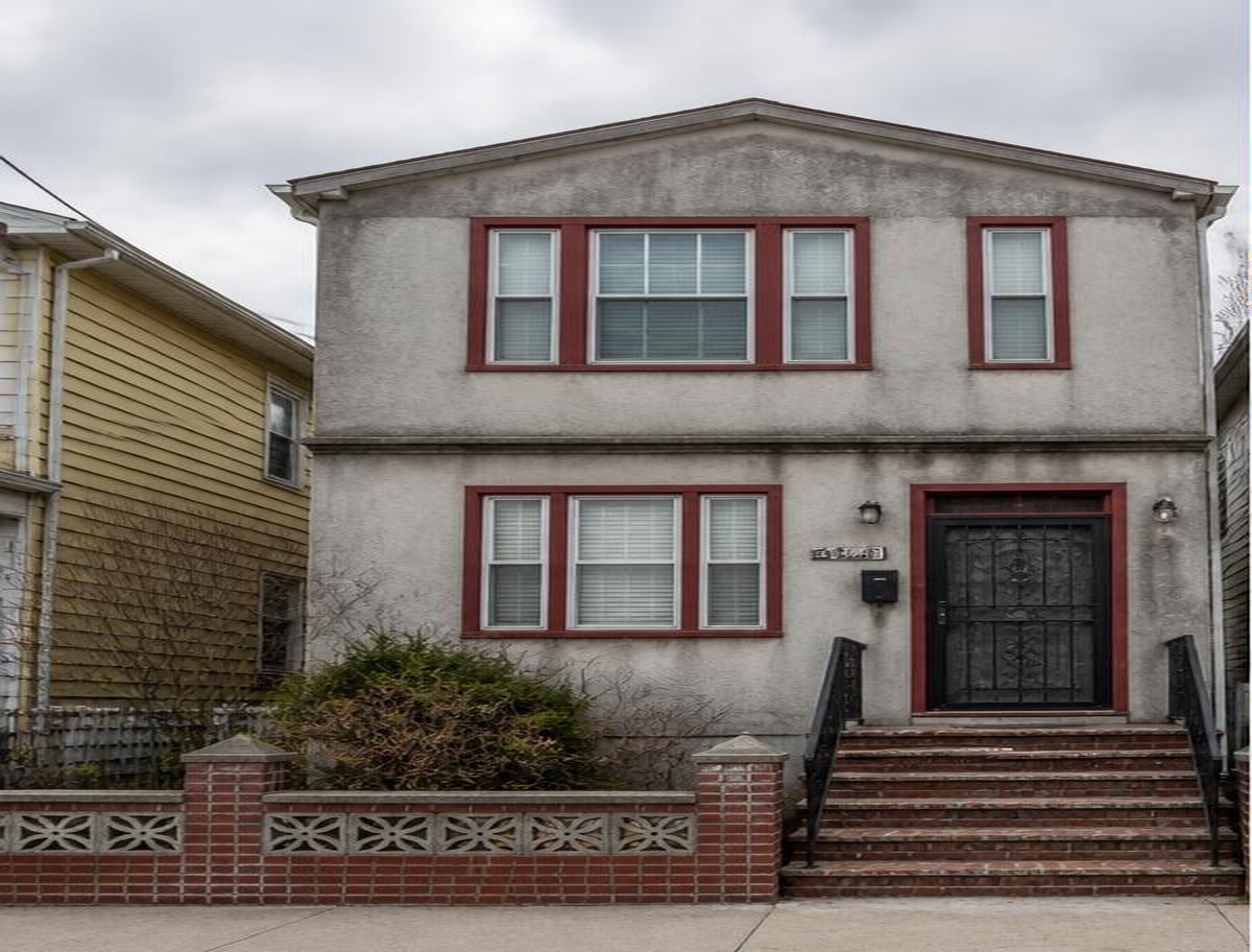 Before — stucco house exterior in Queens, NY